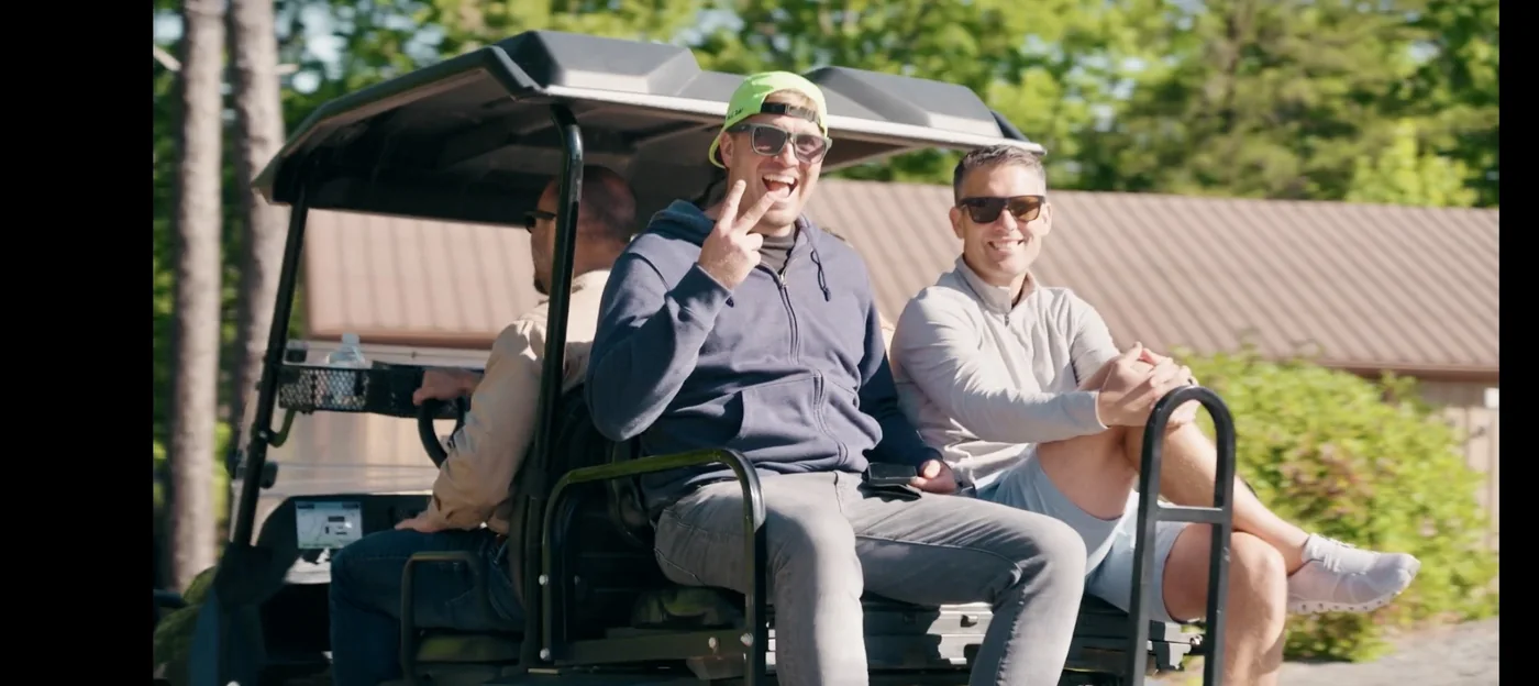Guests smiling together in a cart during their outing at Garland Mountain
