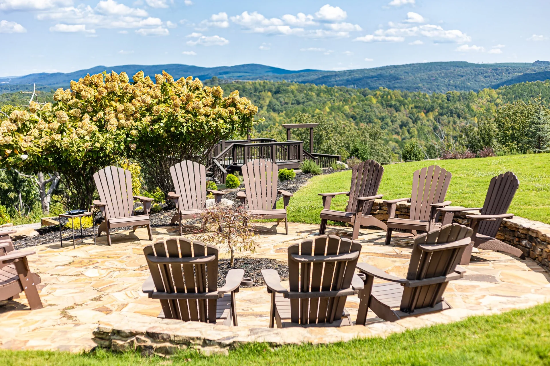 Chairs around the stone firepit overlooking the North Georgia mountains at Garland Mountain